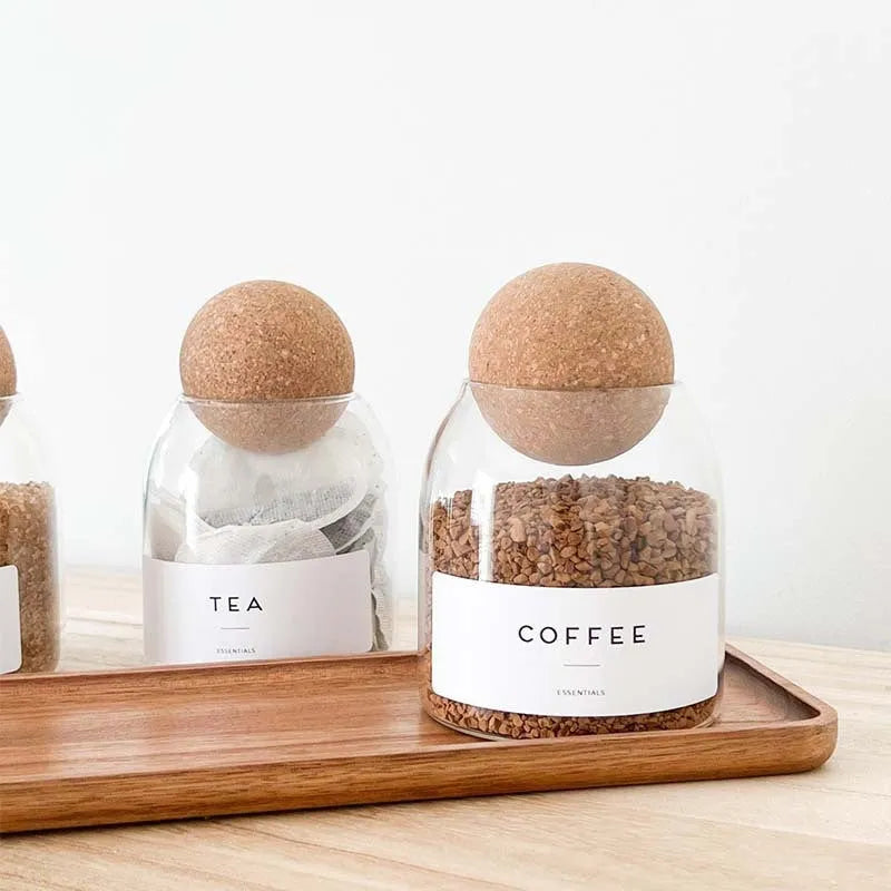 Three transparent glass spherical food storage tanks arranged on a shelf with modern simple design