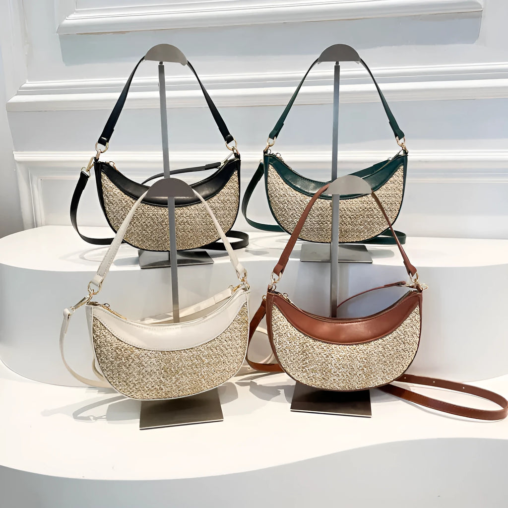 Hard structured straw dumpling shaped women's crossbody shoulder bag in black, shown with interior phone pocket.