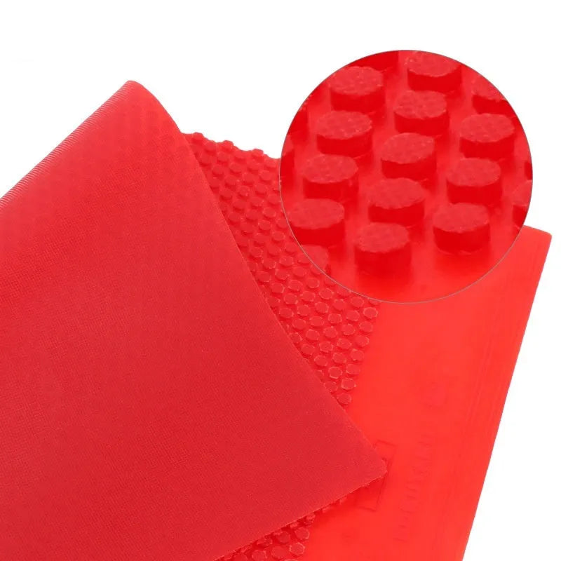 Single sheet of black and red raw table tennis rubber with a small particle surface.