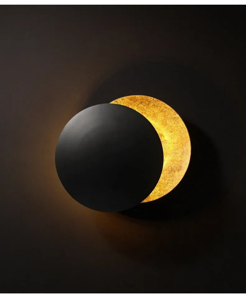 Modern minimalist aluminium bedside lamp in gold and black, shown in 20cm and 25cm diameter options.