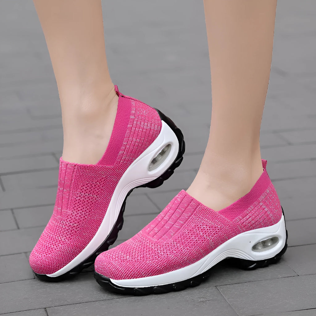 Women's mesh sports shoes in black, side view, showing breathable upper, thick bottom sole, and slip-on design
