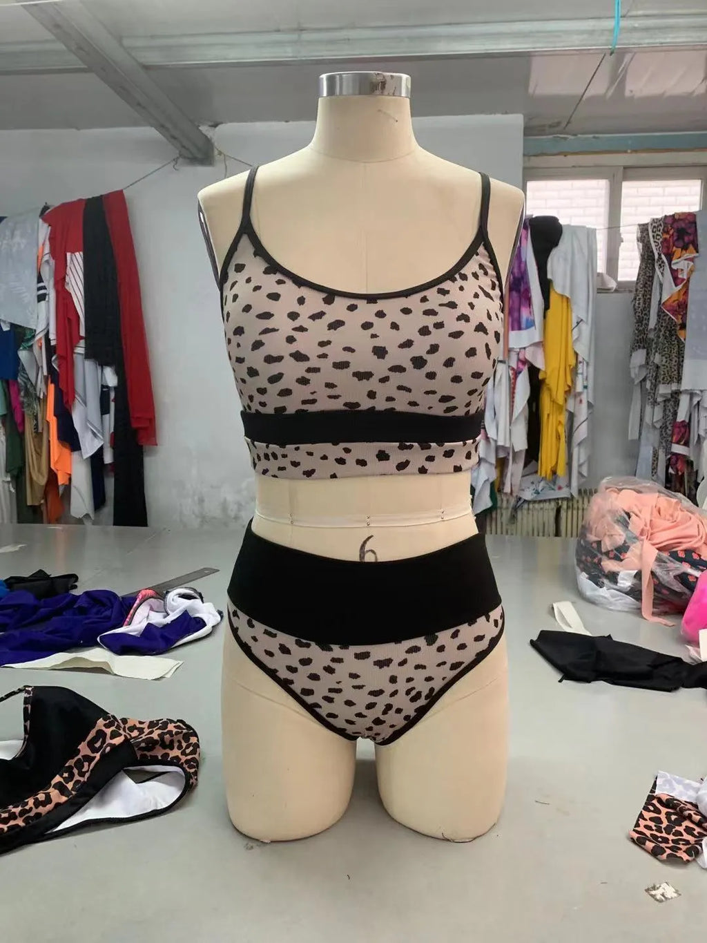 Women's high-waisted leopard print bikini swimsuit top and shorts on a white background.