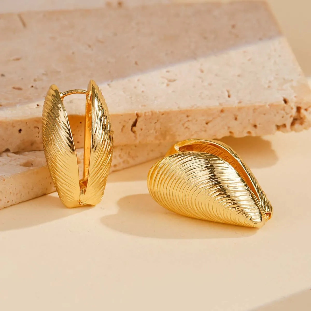 Gold geometric shell thread clip-on earrings on woman, beach ocean vacation style, zinc alloy electroplated ear clips