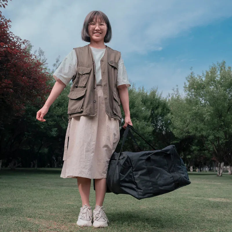 Green and grey waterproof storage bag for camping tents and folding chairs, shown with gear inside and folded compactly.