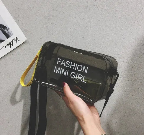 A transparent square jelly cross-body bag in a choice of colours, shown with an adjustable strap and a mobile phone inside.