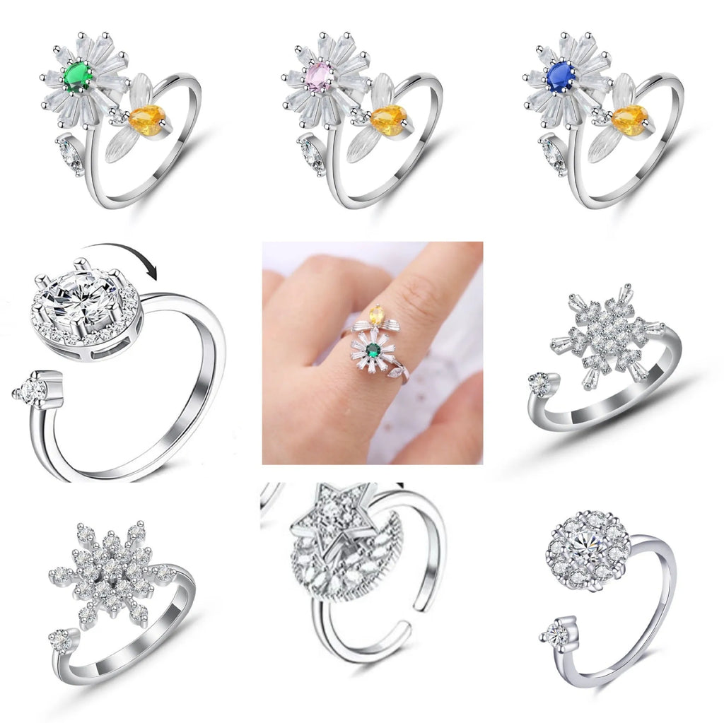 Gold tone adjustable spinner ring with rotating band and bee daisy design with blue zircon stones