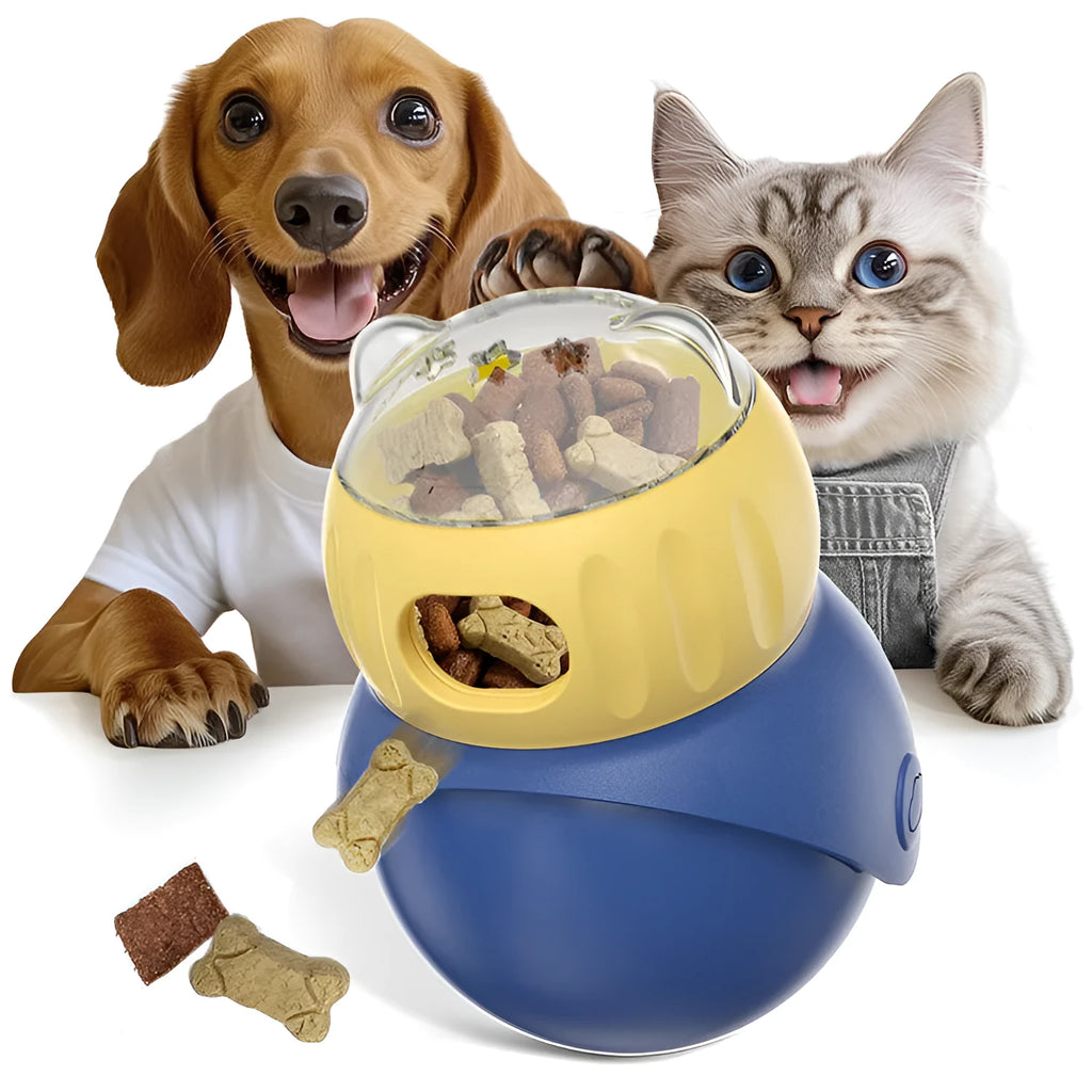 Yellow and blue plastic tumbler owl cat puzzle feeder toy on a wooden floor.