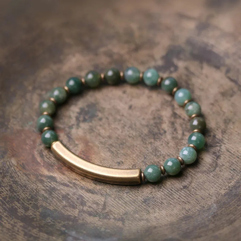 Layered ethnic bracelet with red jasper, obsidian, and green agate stone beads on a brass chain.