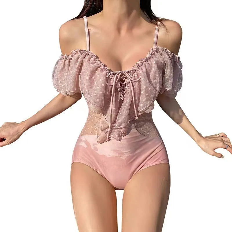 Solid pink women's one-piece swimsuit made of nylon fabric on a white background.