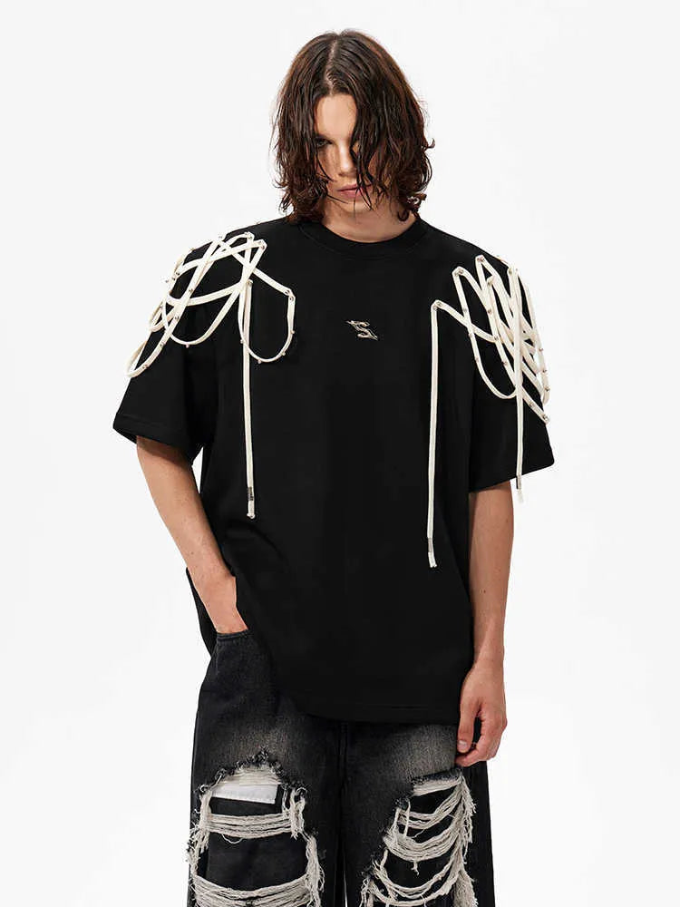 Black loose fit short sleeve t-shirt with padded shoulders and decorative rivet ribbon detail.