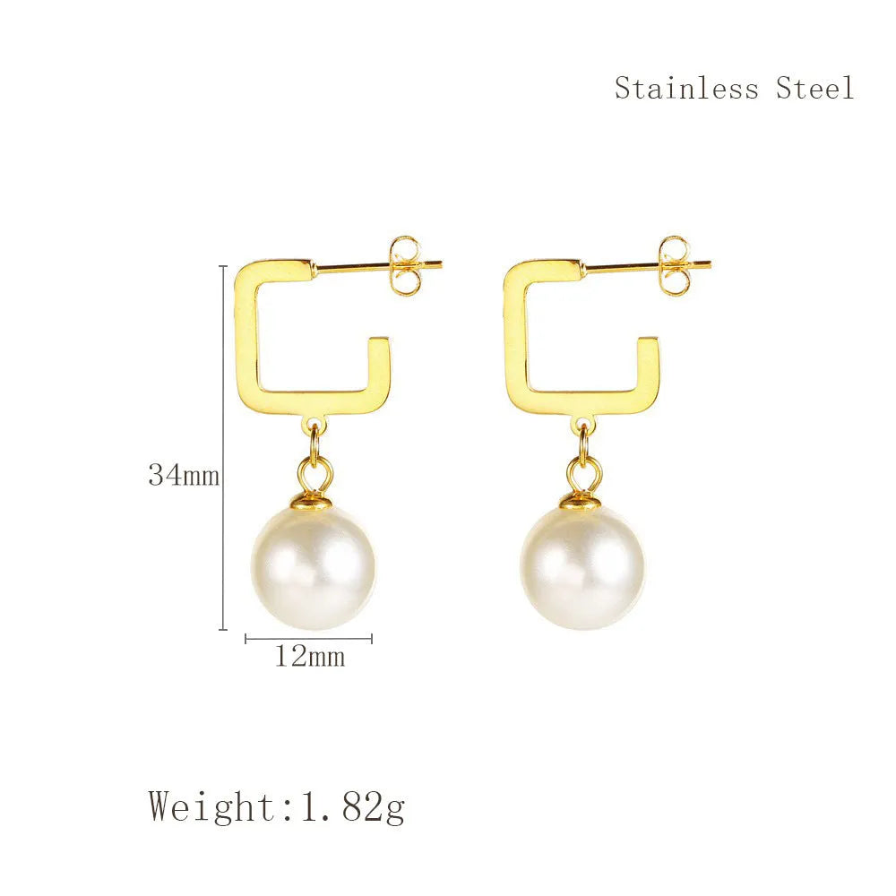Women's gold titanium steel C-shaped earrings with pearl inlay flower design on white background