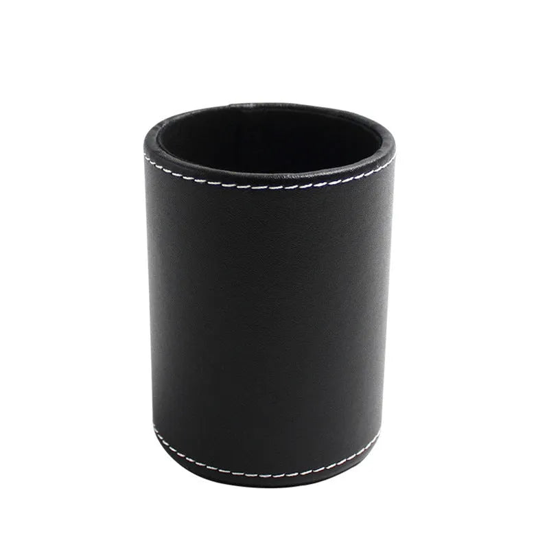 Black leather round pen holder on a desk
