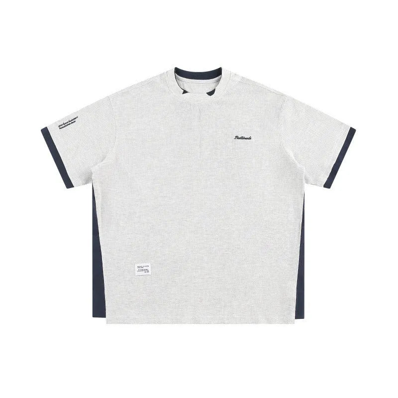 Retro alphabet embroidered loose fit short-sleeved waffle t-shirt on a hanger.