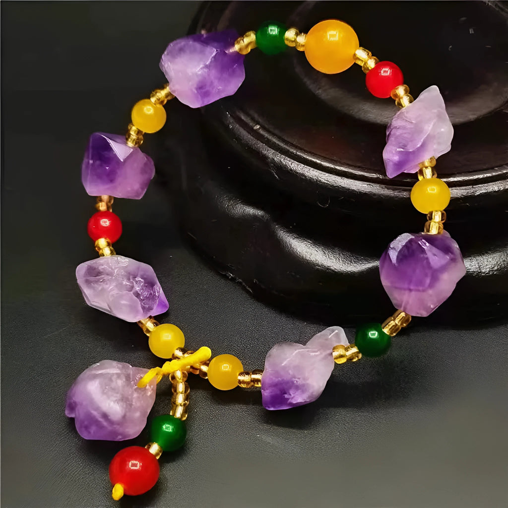 Women's natural amethyst bracelet with a fu character engraved on the central bead.
