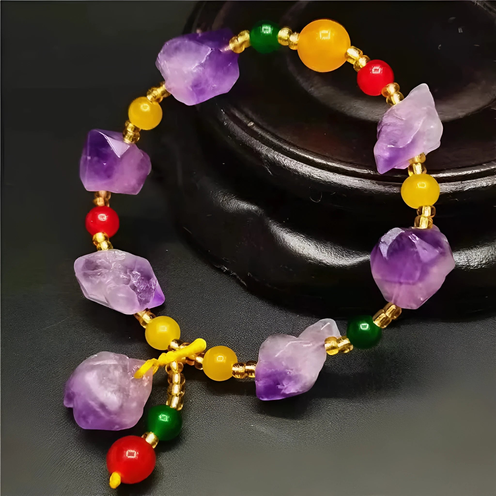 Women's natural amethyst bracelet with a fu character engraved on the central bead.