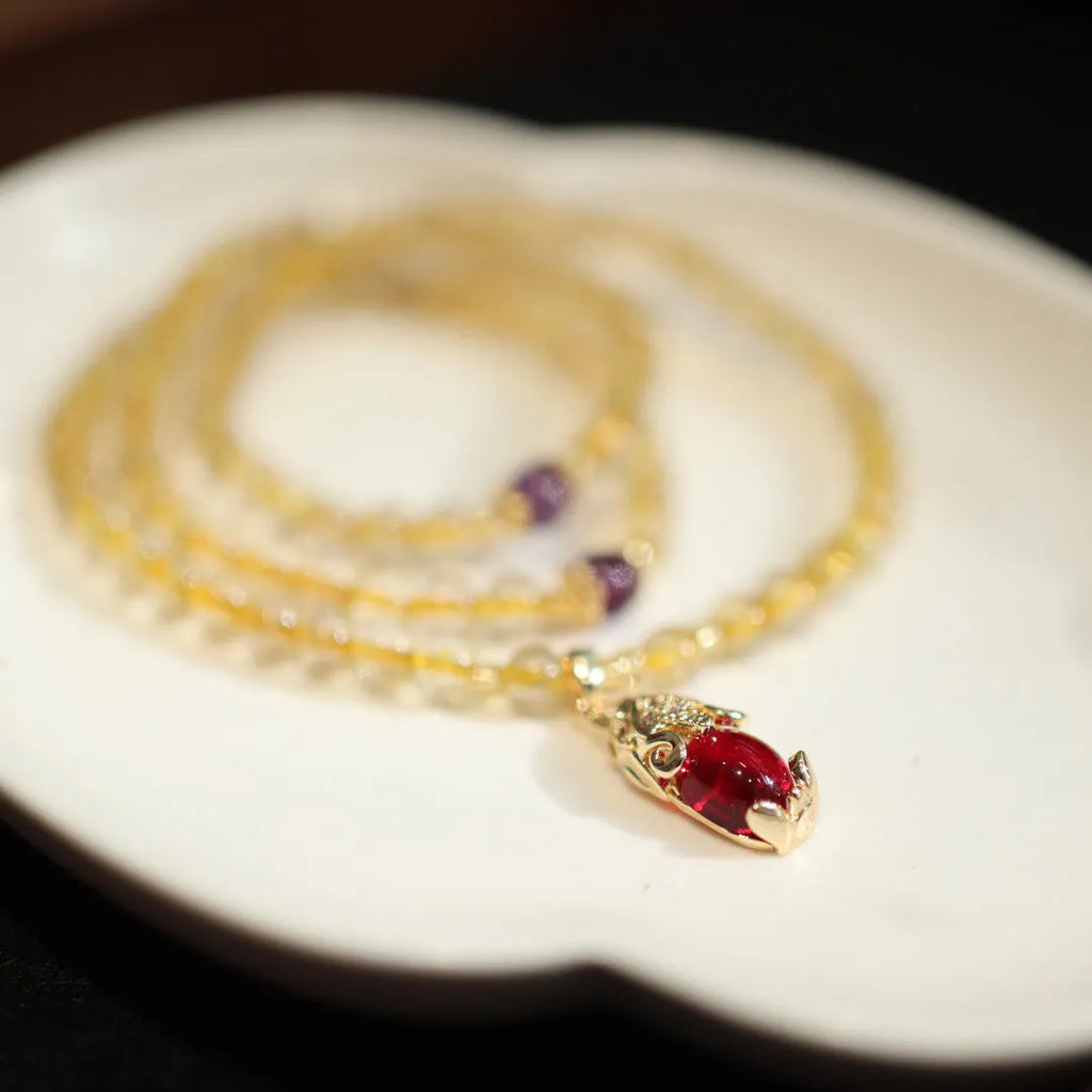 Natural Brazilian rutilated quartz bracelet in Chinese style with three circles and hanging chopsticks.