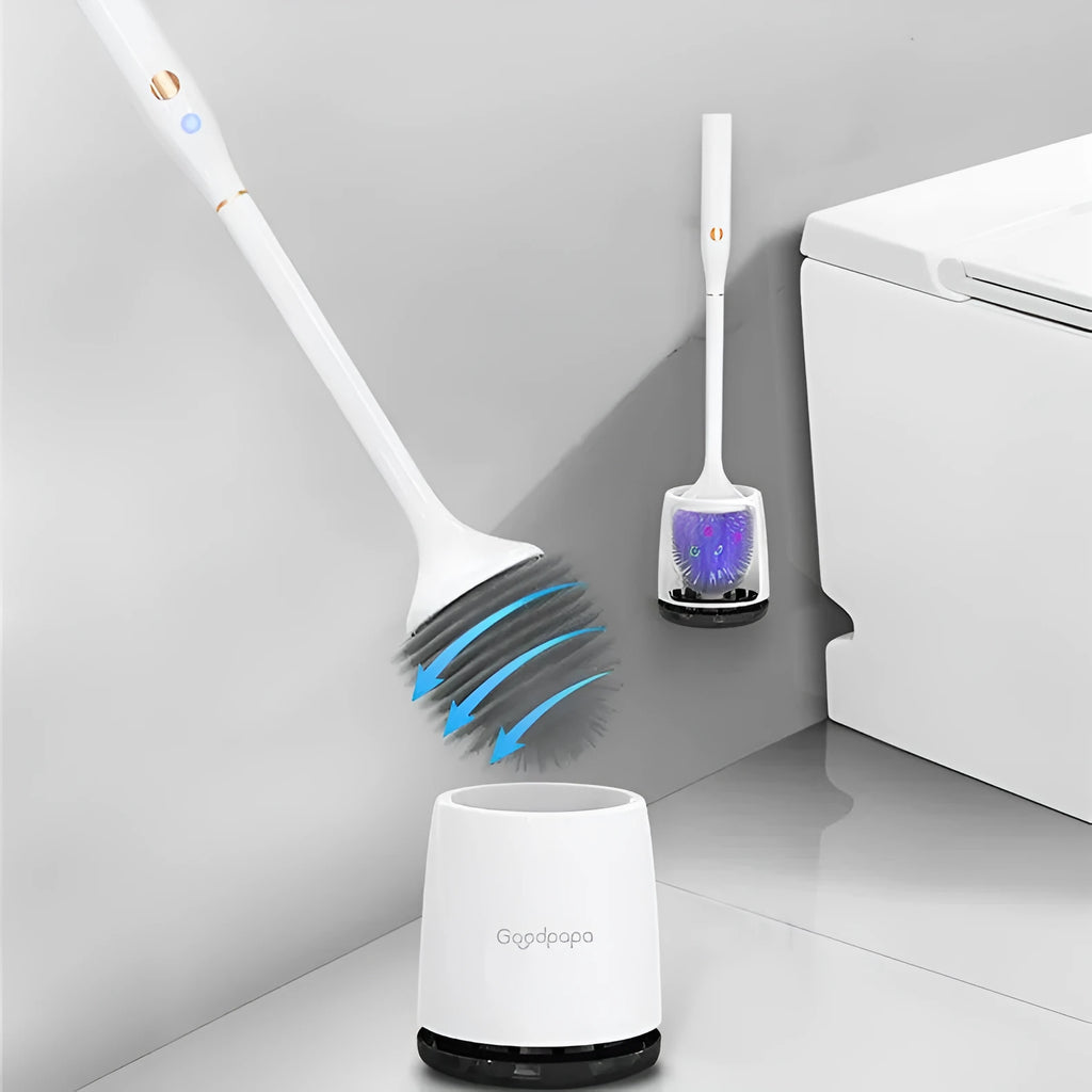 White wireless electric toilet brush with base and USB cable on a bathroom floor