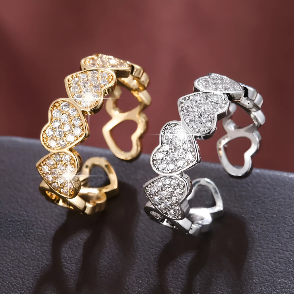 Geometric adjustable couples ring with a love heart design in gold or silver finish.