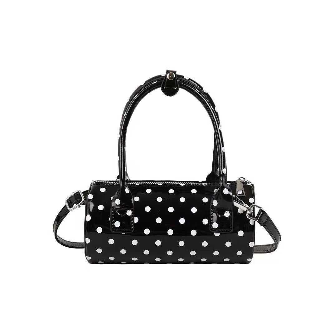 Korean-style PU leather tote pillow bag in black, white, and red colours, cylindrical shape with stitched seams and single shoulder strap, 20x10x10cm