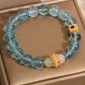 Women's Chinese style crystal bracelet with blue cube sugar beads and colourful stones on flexible ring