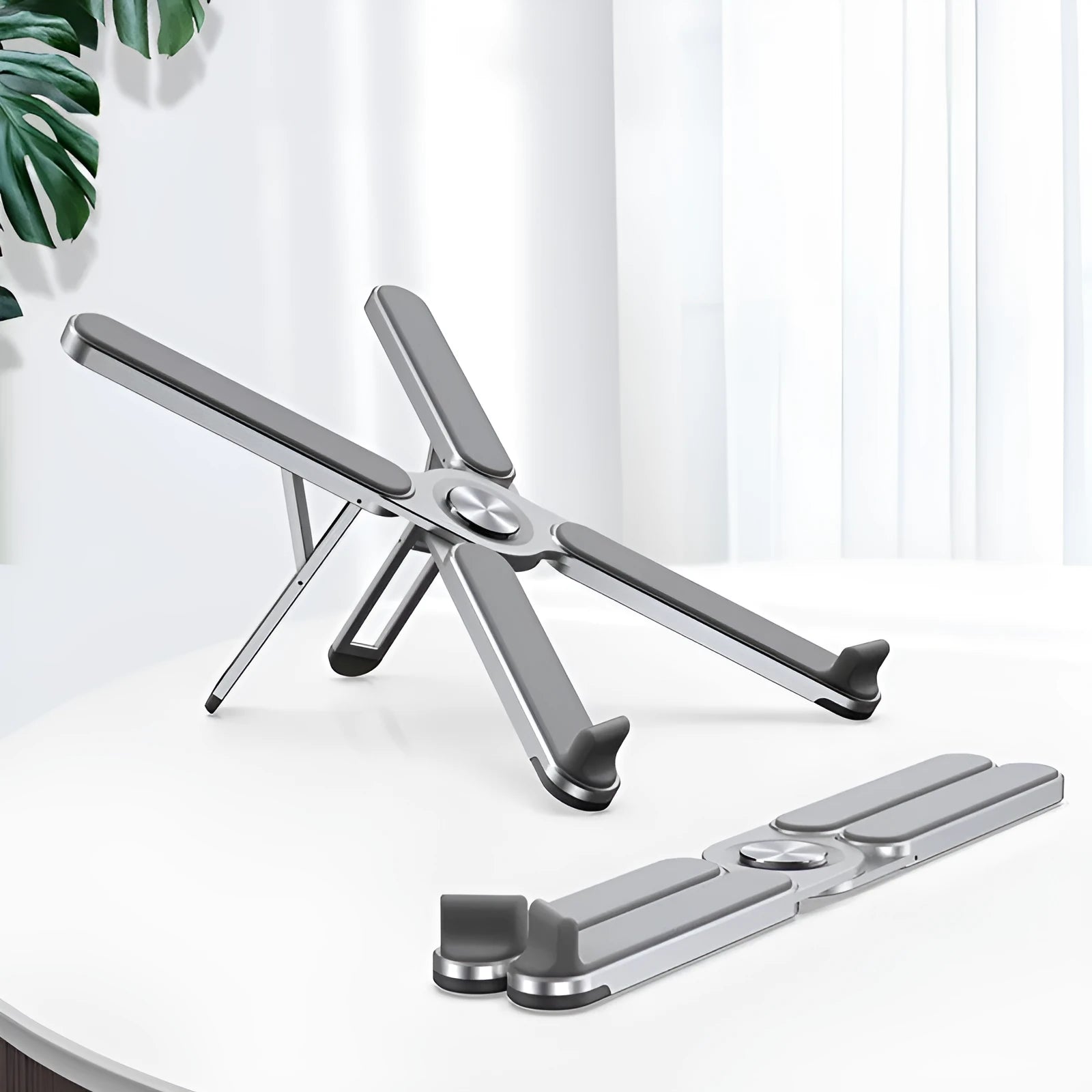 Foldable aluminium alloy laptop bracket in silver on a desk with notebook computer
