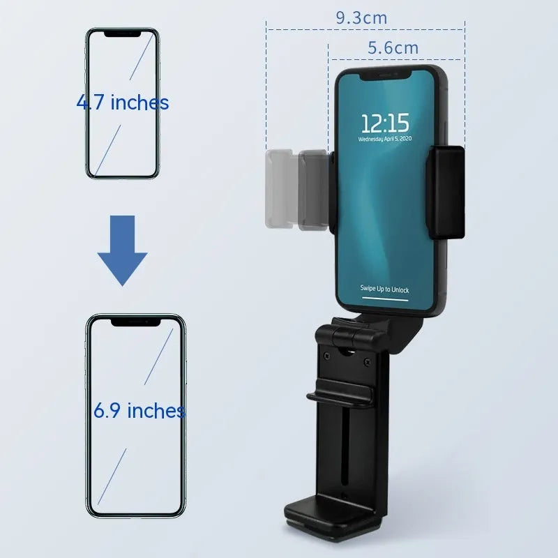 Black foldable ABS phone holder with 360-degree rotation on a desk next to a smartphone