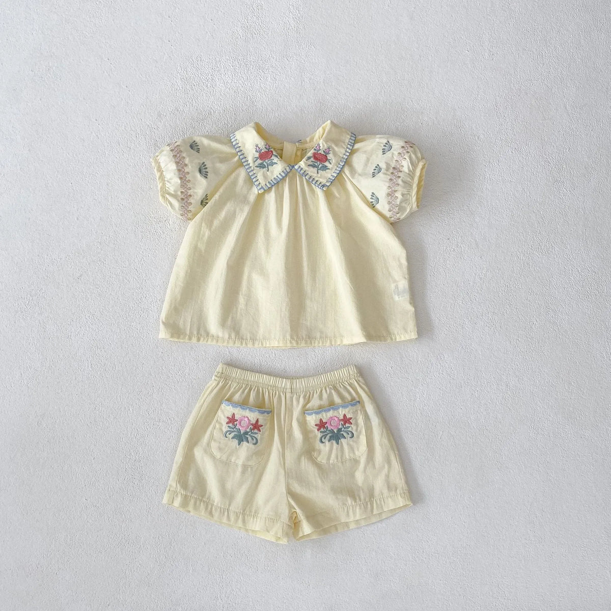 Baby girl yellow cotton suit with flower embroidery on the shirt and matching shorts
