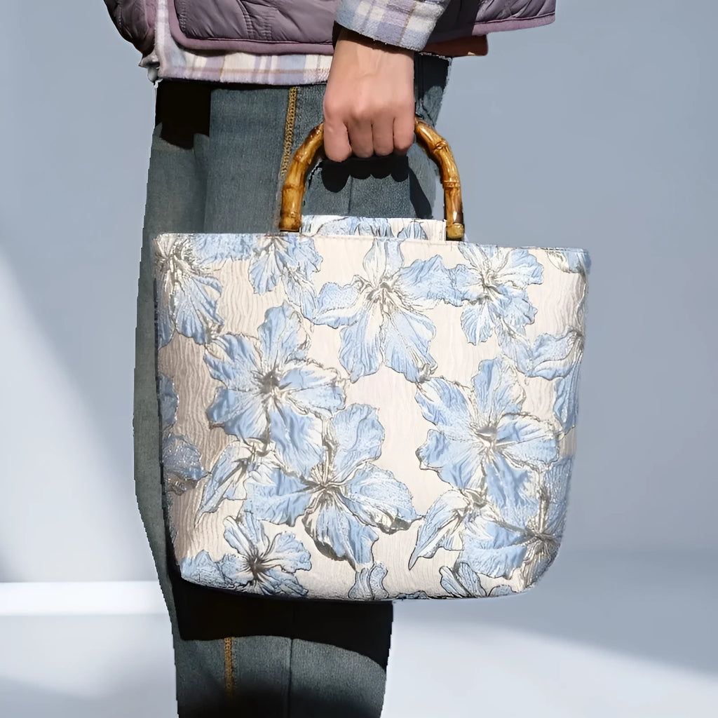 Light blue women's canvas bag with bronzing flower detail and double shoulder straps