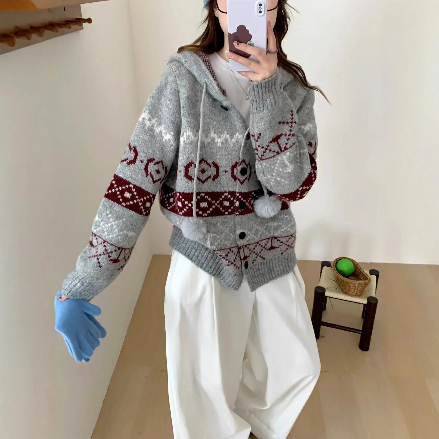 Plus size woman wearing a loose milky white geometric brocade sweater coat with long sleeves.