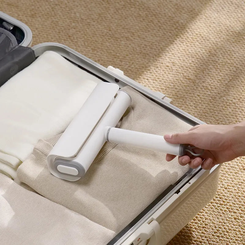 Floor lint remover roller tool for pet hair and dust removal with refillable adhesive roller core.