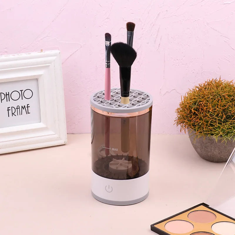 Electric makeup brush cleaner in grey and white with brush inserted, 17x9x9 cm, USB charging
