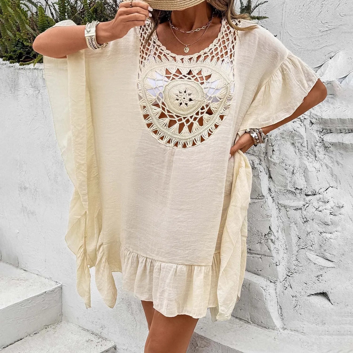 Apricot coloured beach dress with crochet stitching and tassel trim on a patchwork skirt.