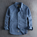 Men's light blue cotton long sleeve shirt with a regular fit and cardigan style on a hanger.
