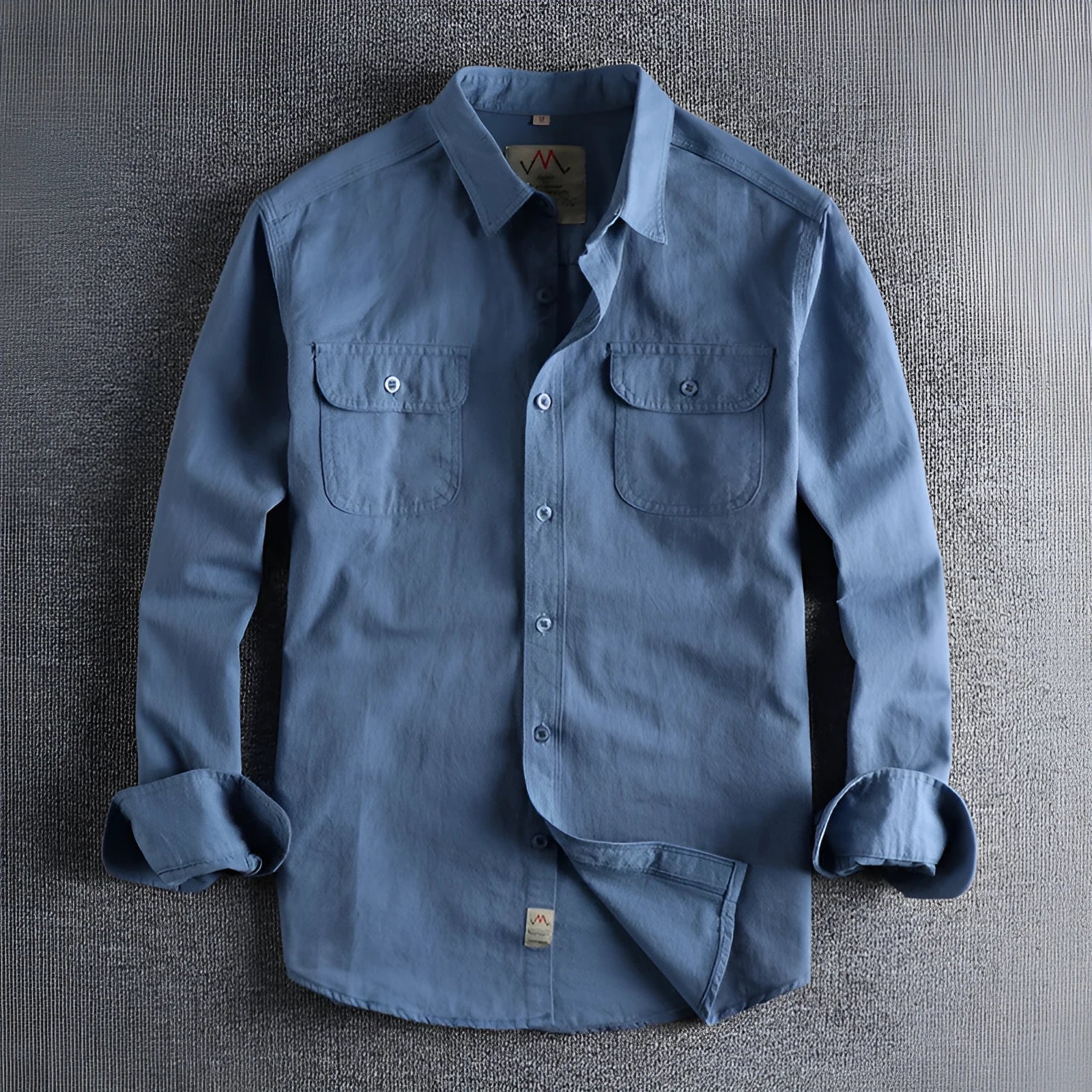 Men's light blue cotton long sleeve shirt with a regular fit and cardigan style on a hanger.