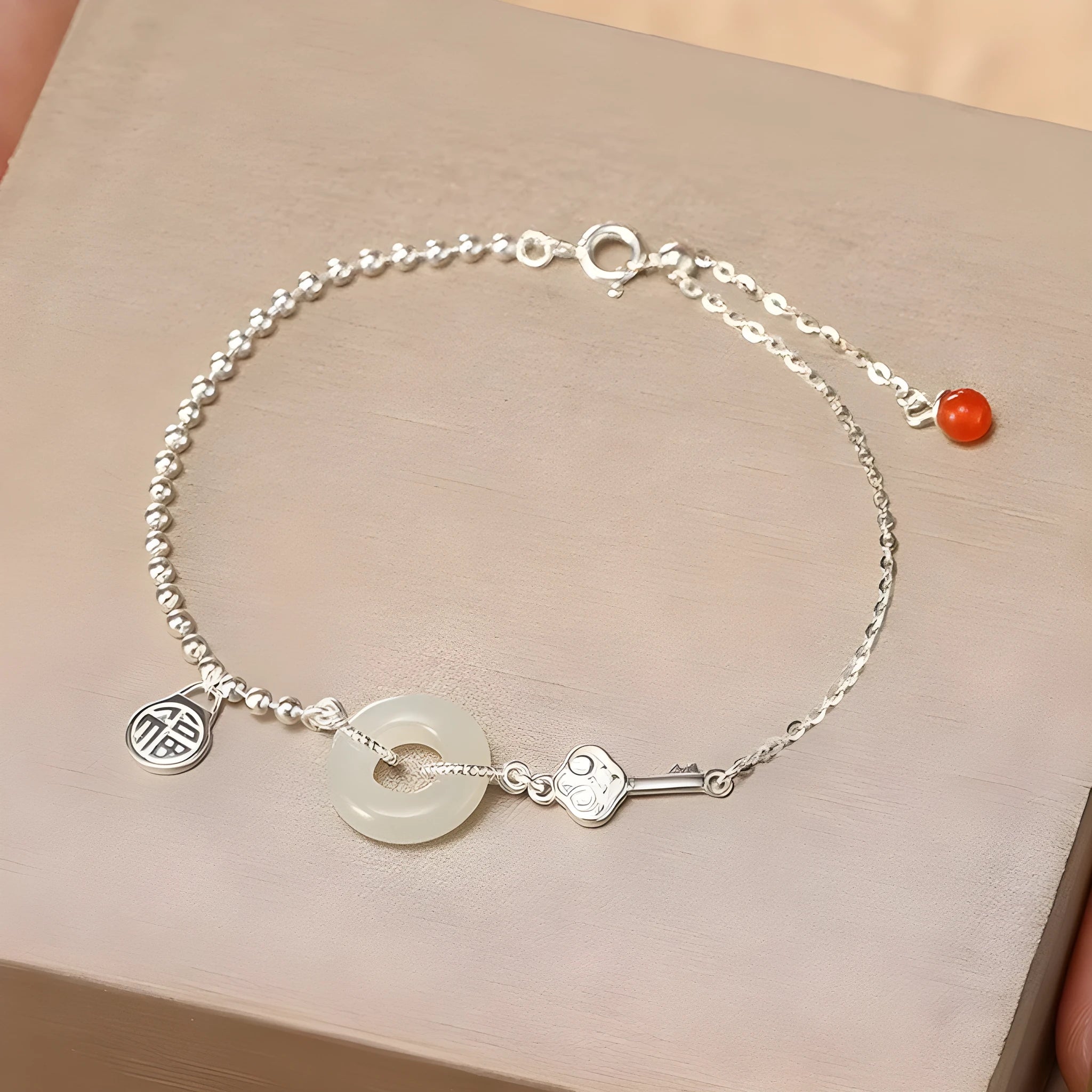Women's silver bracelet with Hetian jade and geometric peace buckle design in Chinese style