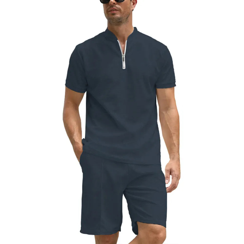 Men's solid colour polo shirt and matching trousers two-piece suit set on a hanger.