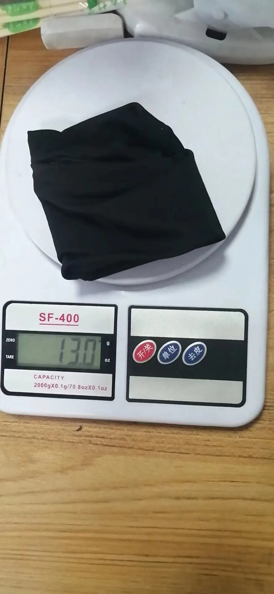 Compact black wrist bag armband sleeve for phone, shown with OPP packaging, dimensions 10cm by 10.5cm.