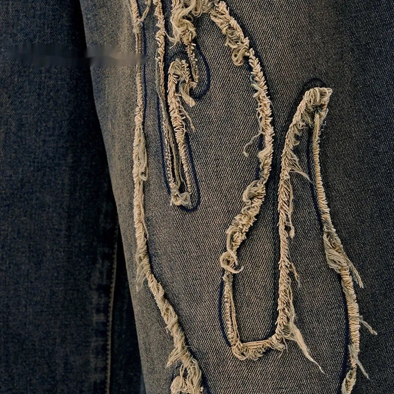 Men's black denim shorts with flame embroidery and a cropped patch on the leg.