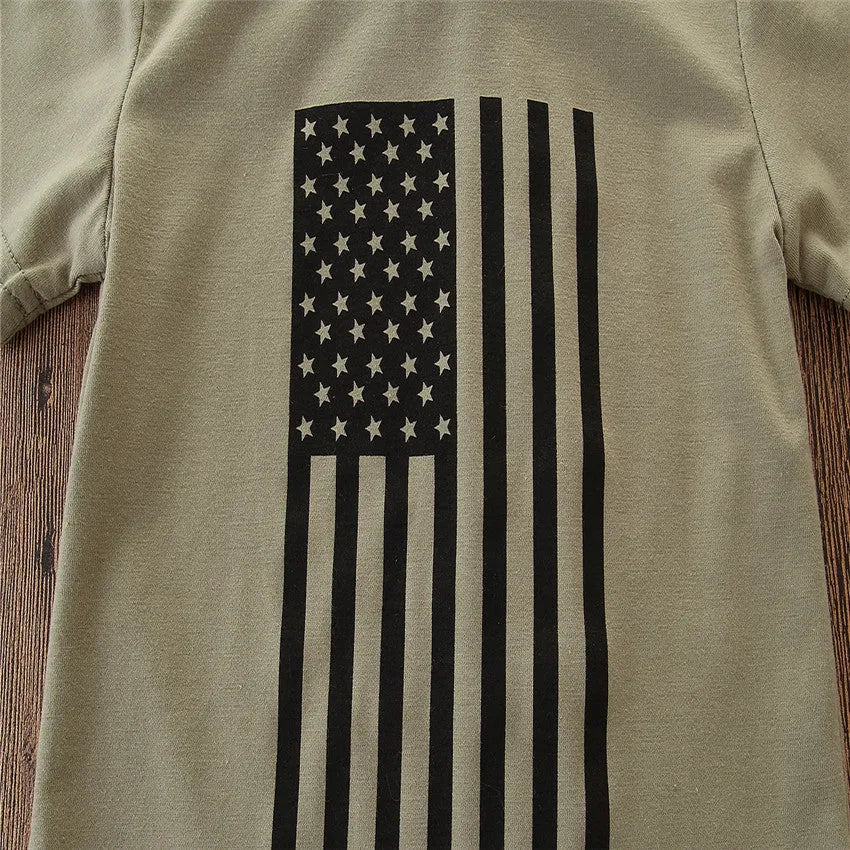 Little boy wearing a US flag camouflage print short-sleeved shirt and matching trousers.