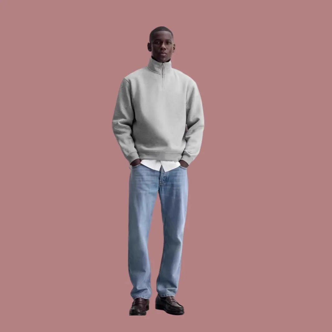Grey half zip stand collar cotton sweater for men and women on a hanger.