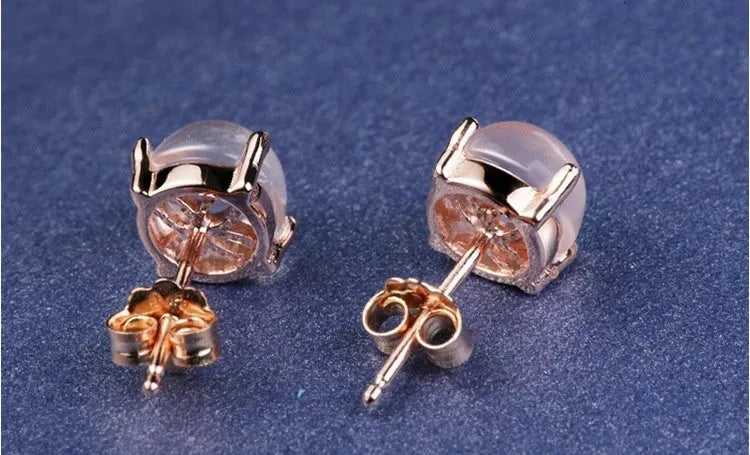 Women's rose gold drop shape stud earrings with synthetic ross quartz crystal inlay