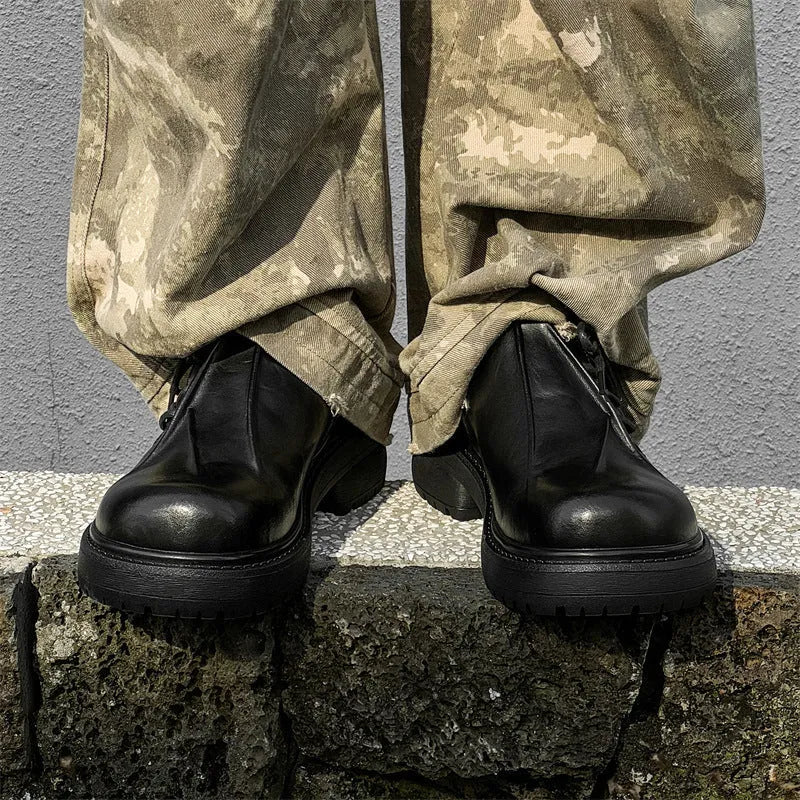 Black low-top platform shoes with round toe cap and rubber sole for men and women.