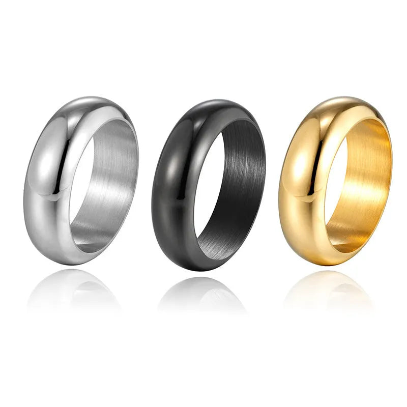 A glossy electroplated titanium steel ring in a gold colour, shown on a finger.