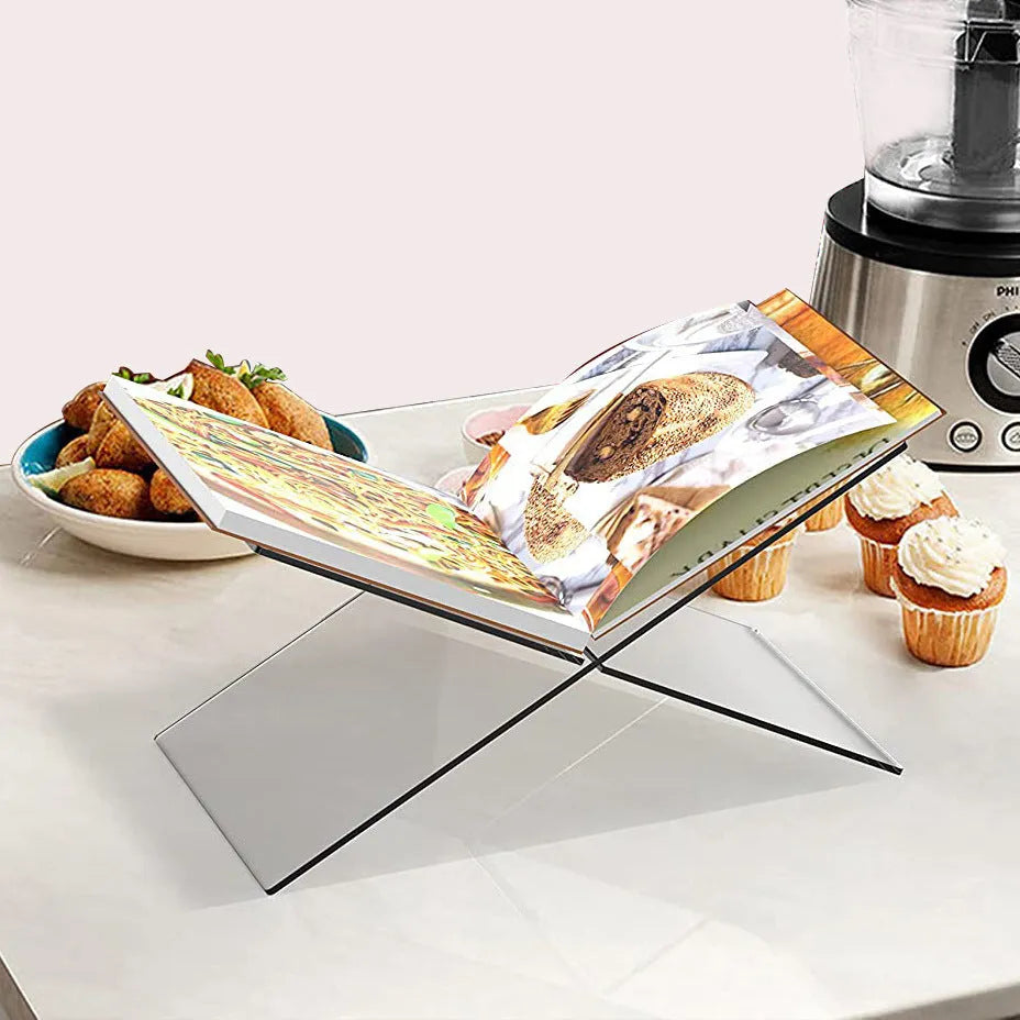Clear acrylic X-shaped book display shelf holding books at an angle