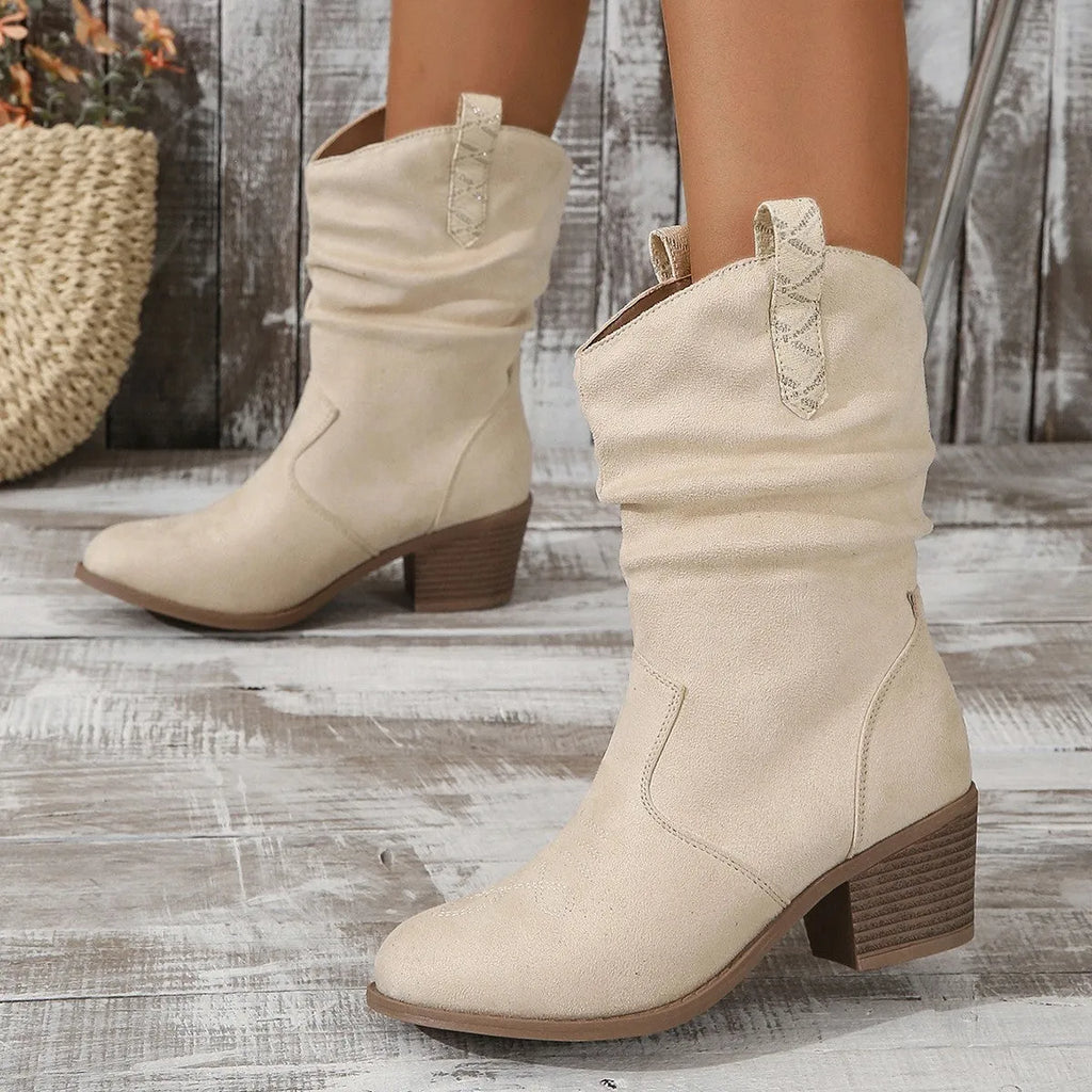 Mid-calf suede boots with a block heel and pointed toe in lotus root colour on a neutral background.