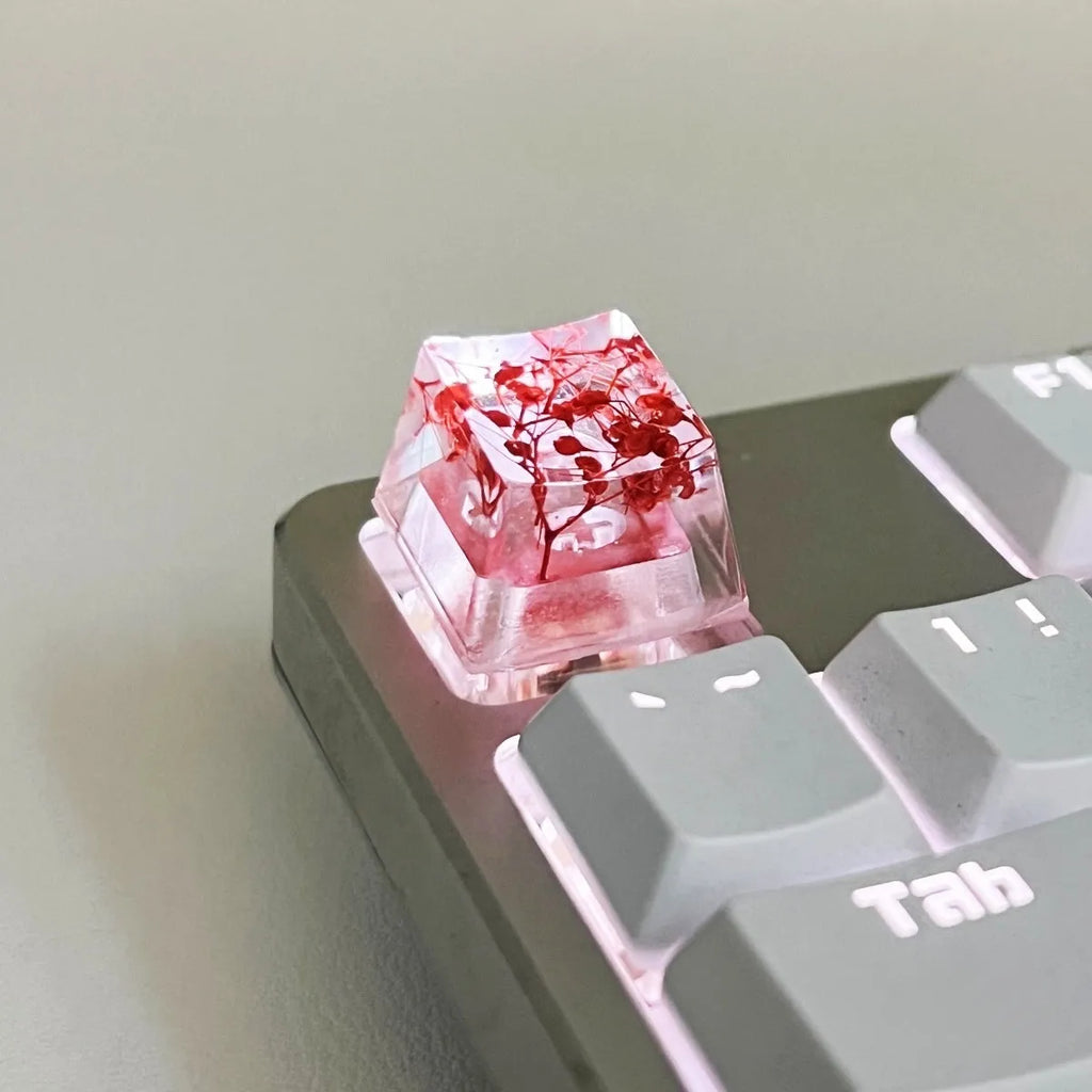 High transparency resin keycap with starry sky pattern in green, shown next to a mechanical keyboard.