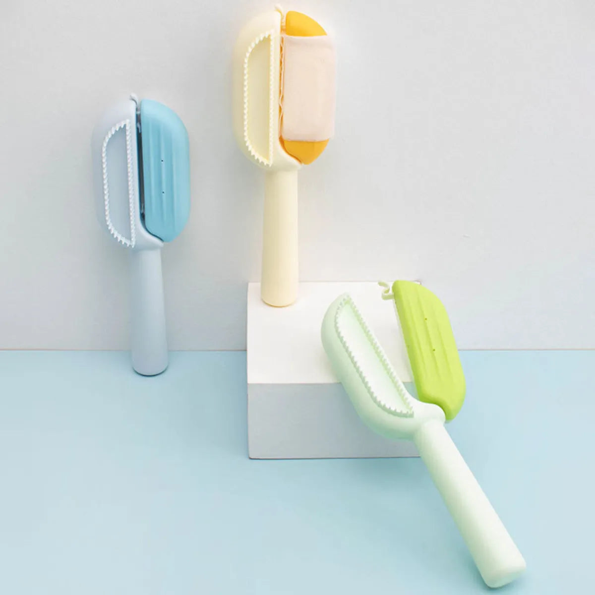 Blue pet grooming comb with water tank for collecting hair during brushing of dogs and cats.