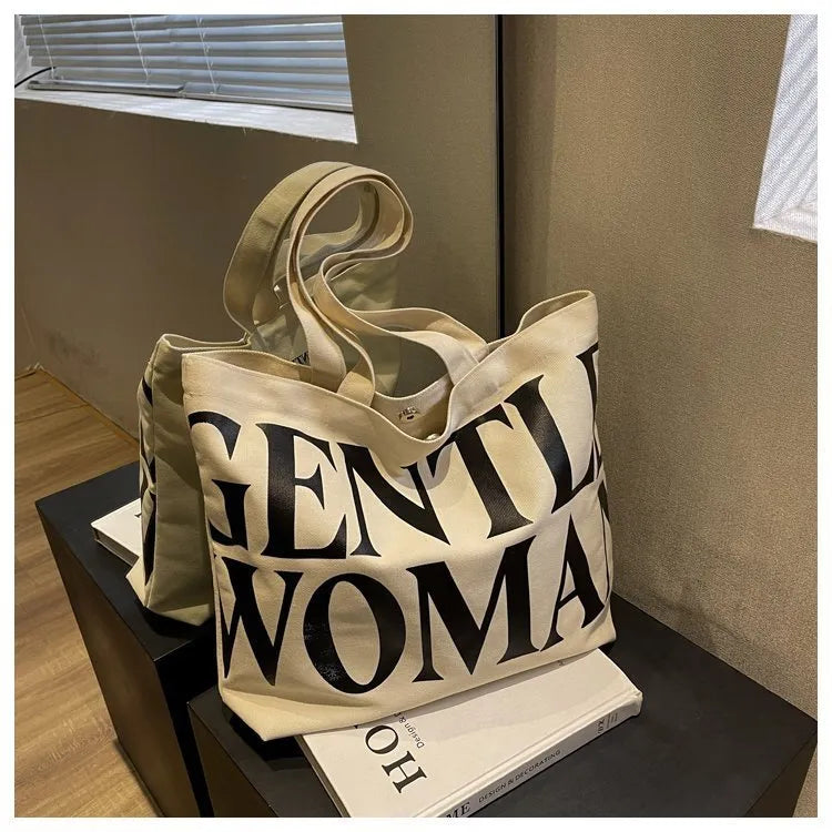 Large capacity canvas tote bag with letter print and upgraded zipper, off-white colour, on plain background
