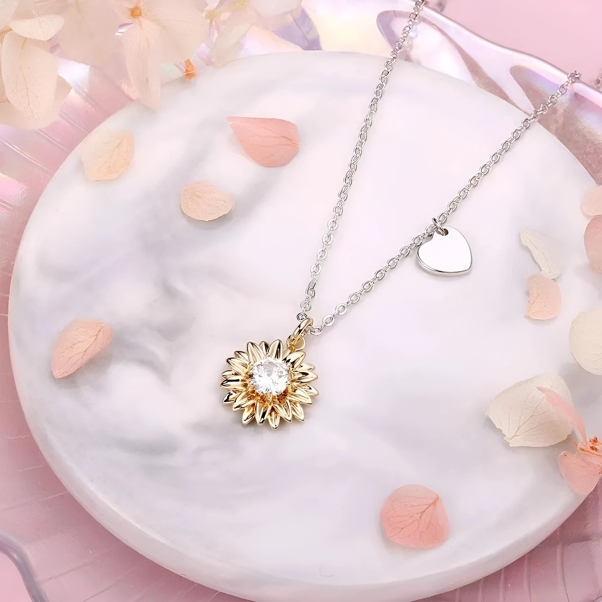 Silver sunflower necklace with geometric pendant and cross chain on a model.