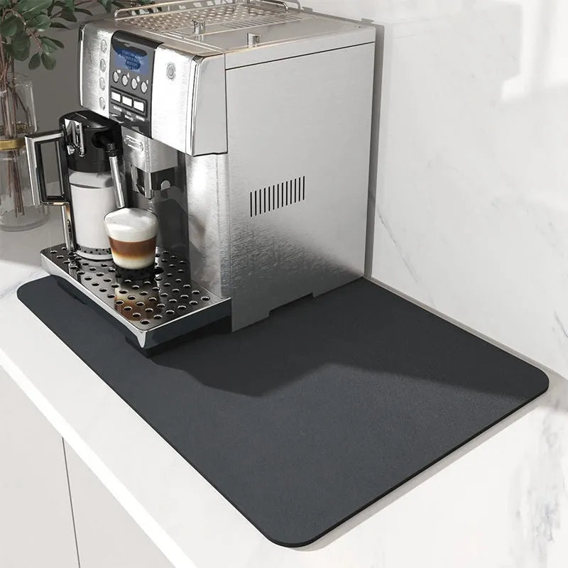 Black super absorbent rubber-backed kitchen drain mat on a countertop